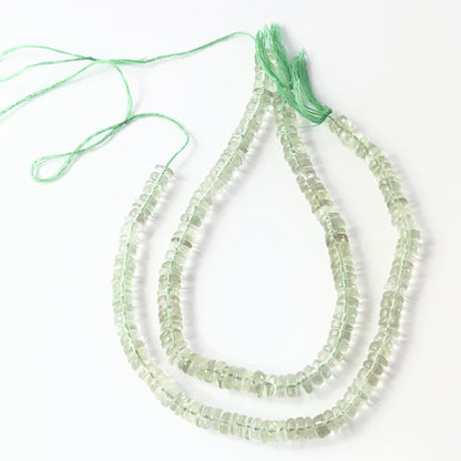 Close-up of polished green amethyst wheel beads, 5.5–6.0mm, strung on a 21cm strand.