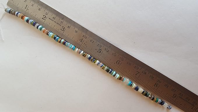 A ruler measuring the length of a strand made with Heishi smooth wheel 5.5mm gemstone beads. 
