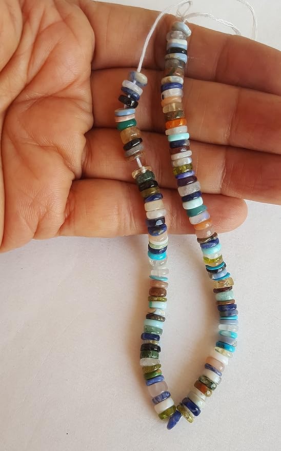 Close-up of a person holding a colourful gemstone strand made with Heishi smooth wheel beads, showcasing its vibrant design.