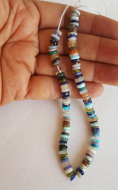 Close-up of a person holding a colourful gemstone strand made with Heishi smooth wheel beads, showcasing its vibrant design.