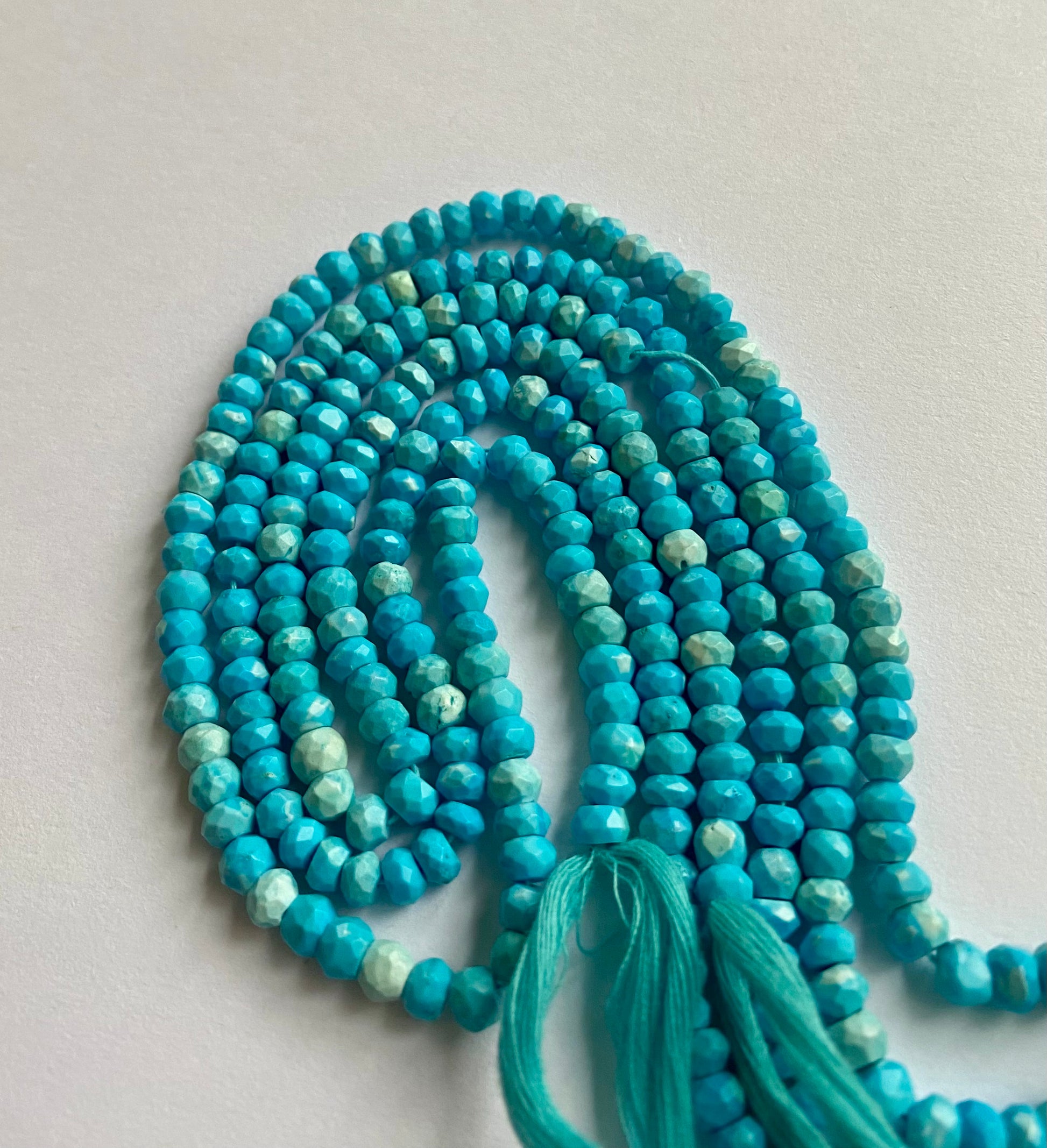 Strand of howlite turquoise rondelle beads, 4.5-5.0mm, beautifully threaded.