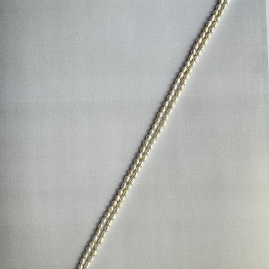 Close-up of freshwater pearl smooth rice beads, highlighting their polished finish and creamy white tones.