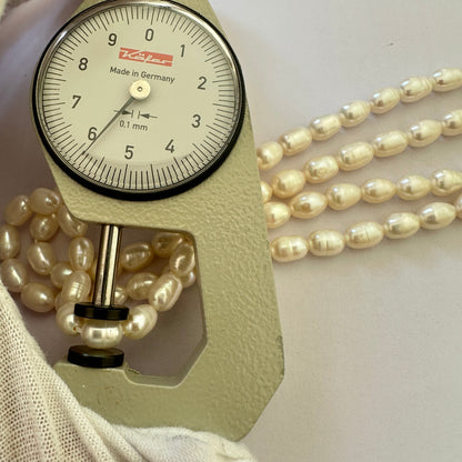 A dial gauge measures the Freshwater Pearl textured oval 8.6 x 6.2mm gemstone.