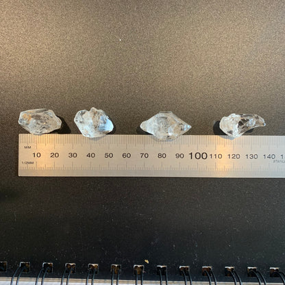 A ruler measures the Herkimer Diamond rough undrilled 21mm gemstone, ensuring precise sizing.