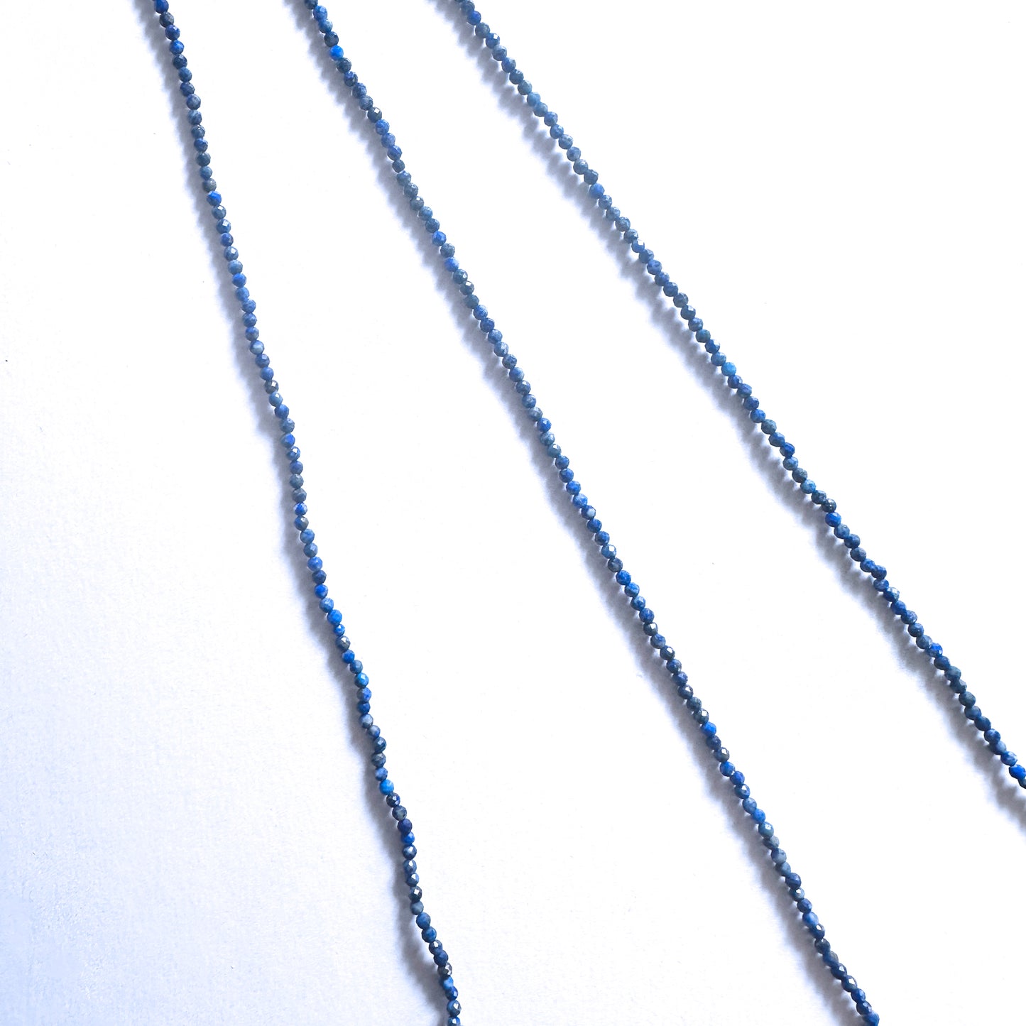 Premium Lapis Lazuli rondelle beads with golden pyrite accents and refined faceted cut.
