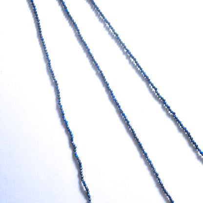 Premium Lapis Lazuli rondelle beads with golden pyrite accents and refined faceted cut.