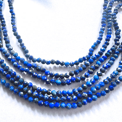 Lapis Lazuli gemstone beads in faceted rondelle shape reflect light with subtle brilliance