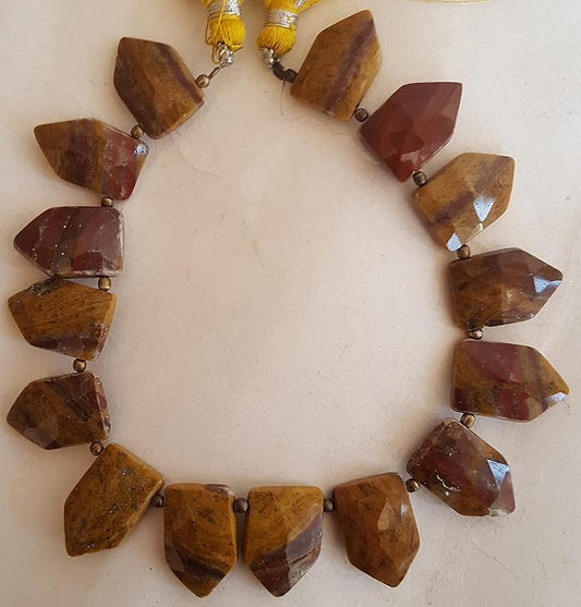 Strand featuring yellow and brown  Jasper stones, with faceted fancy-shaped beads ranging from 11mm to 17mm.