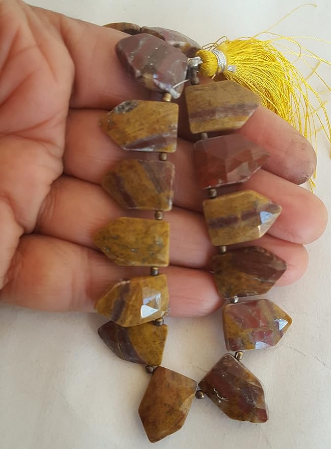 Strands featuring Jasper faceted gemstones, each bead measuring 11mm to 17mm, showcasing natural texture.