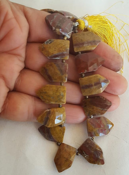Strands featuring Jasper faceted gemstones, each bead measuring 11mm to 17mm, showcasing natural texture.