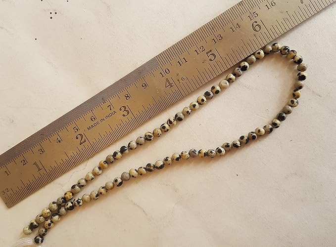 A ruler next to a strand featuring smooth round jasper beads, measuring 4mm to 4.5mm in size.