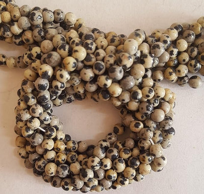 A vibrant strand showcasing diverse smooth, round jasper beads, sized 4mm to 4.5mm.  