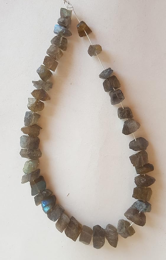 A close-up of labradorite beads, rough centre-drilled, displaying a stunning mix of yellow and brown colours in a strand.