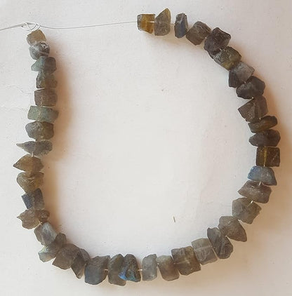 A strand of rough centre-drilled labradorite beads featuring yellow and brown hues, showcasing their unique natural beauty.