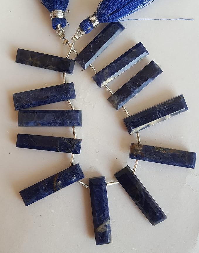  Close-up of a blue gemstone bead strand  highlighting lapis lazuli faceted briolette gemstones.