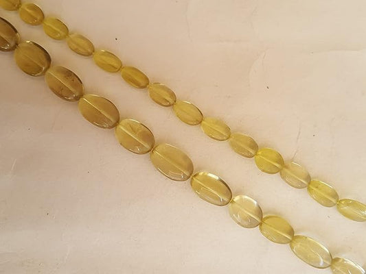  A vibrant gemstone bead strand, adorned with lemon quartz smooth oval gemstones.