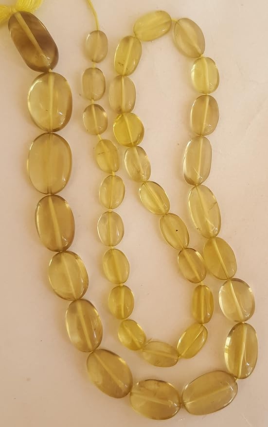A yellow gemstone bead strand showcasing lemon quartz smooth oval gemstones.