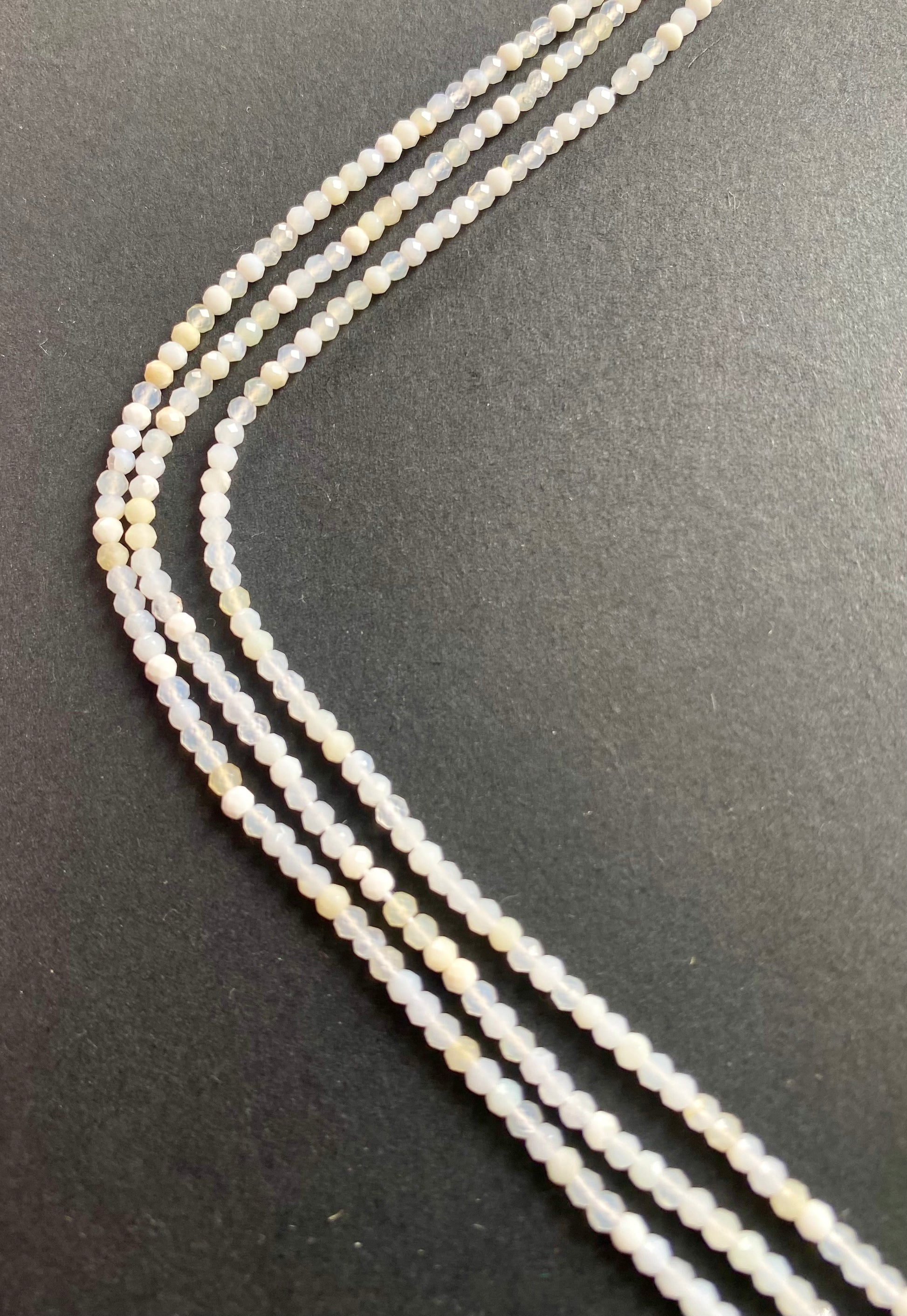 Vibrant strands featuring 2.6-2.7mm micro-faceted opal beads in various colours, highlighting their beauty.
