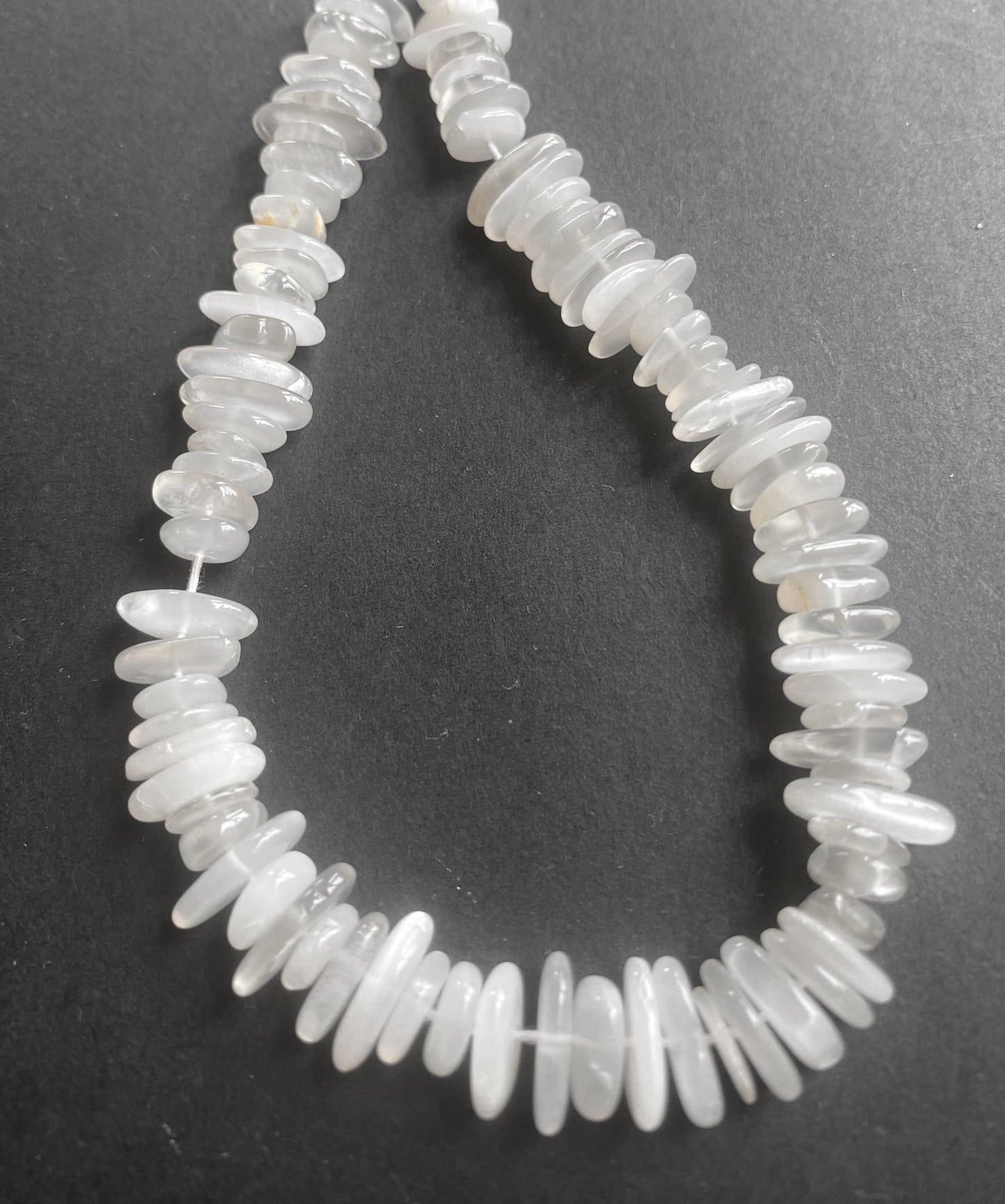 Moonstone smooth chip beads with a radiant, milky glow arranged on a 22cm strand.