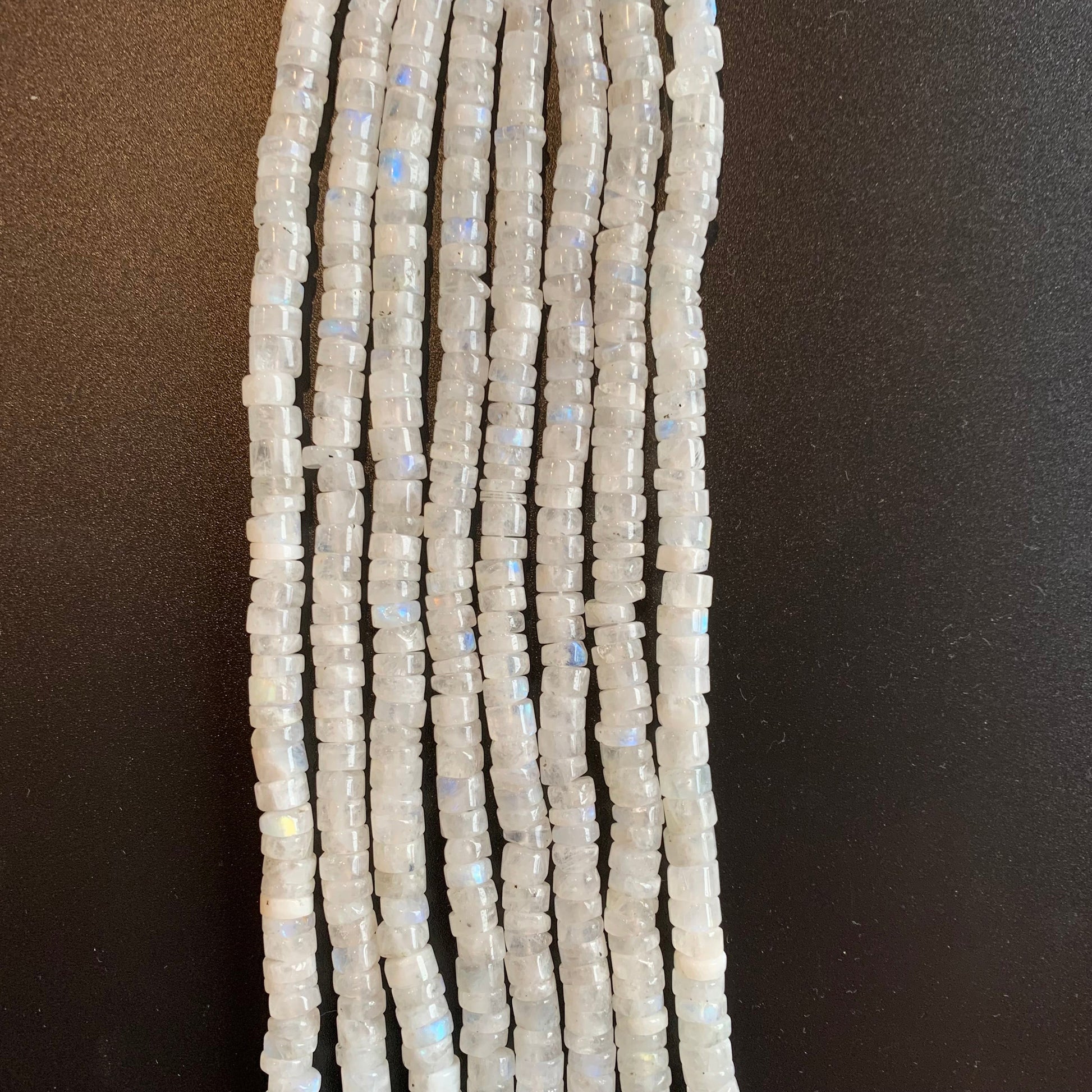 Close-up of Moonstone smooth wheel beads, highlighting their soft glow and natural translucency.