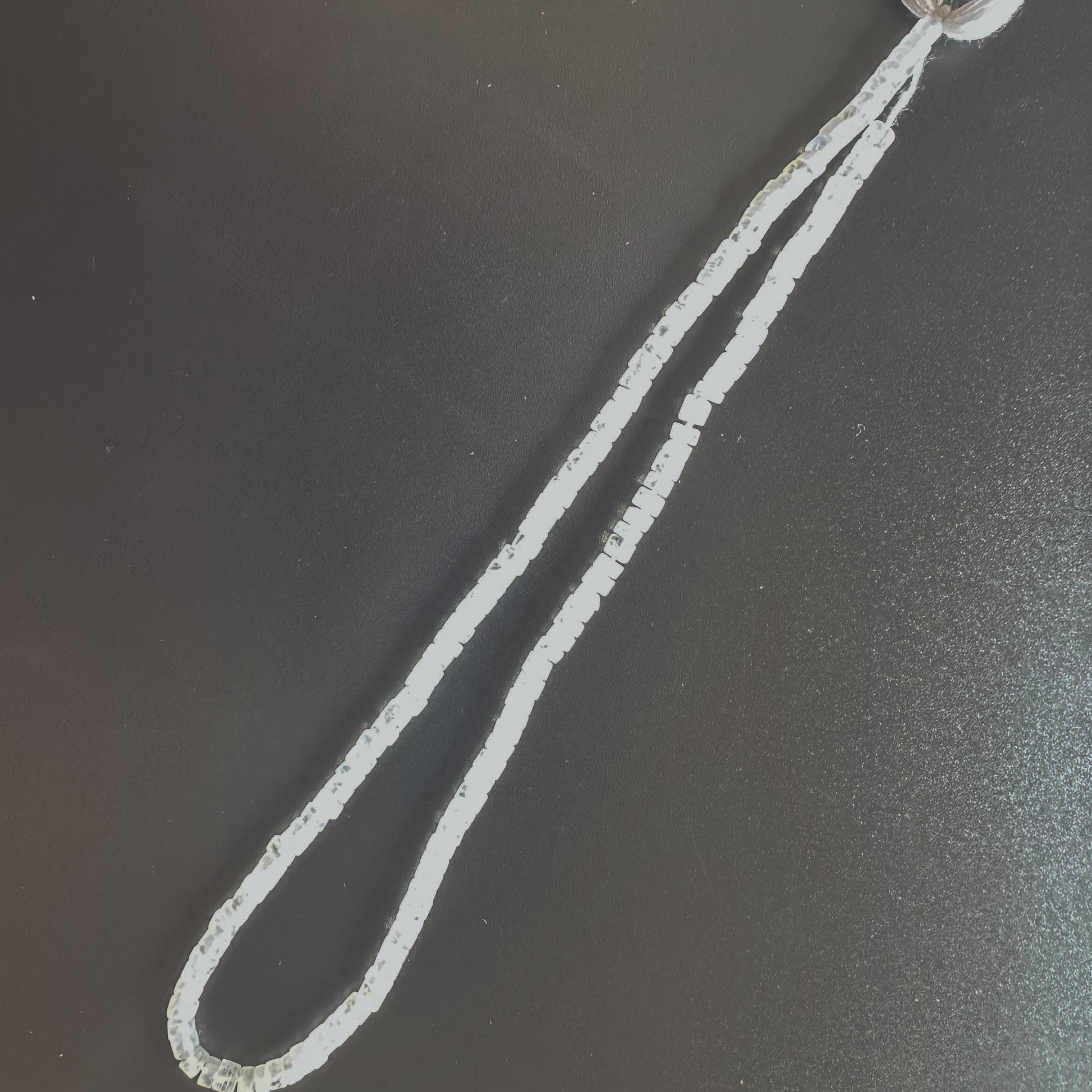 Moonstone beads arranged in a neat strand with consistent shape and radiant glow.