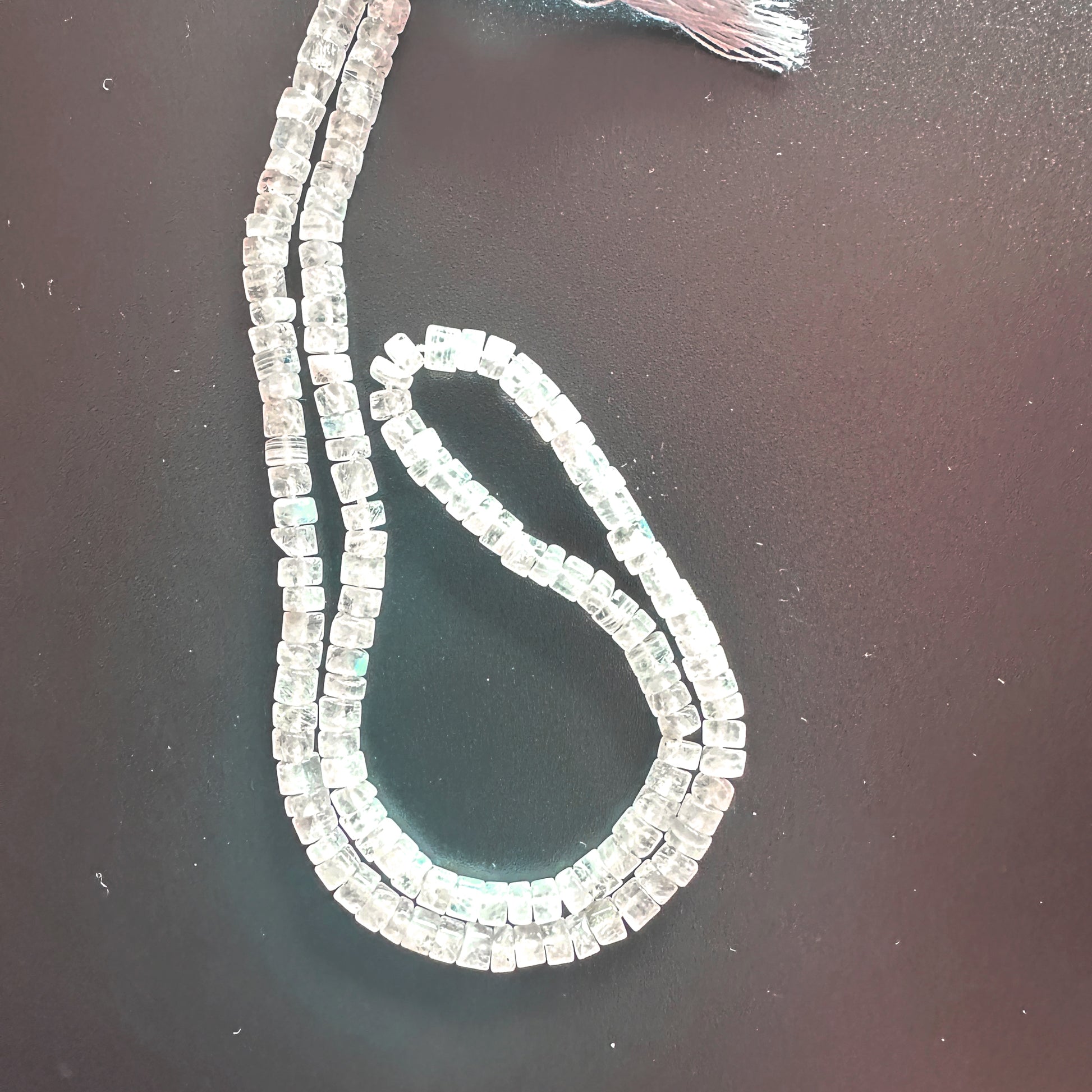 Moonstone smooth wheel beads with pastel hues and glossy finish on a 35cm strand.