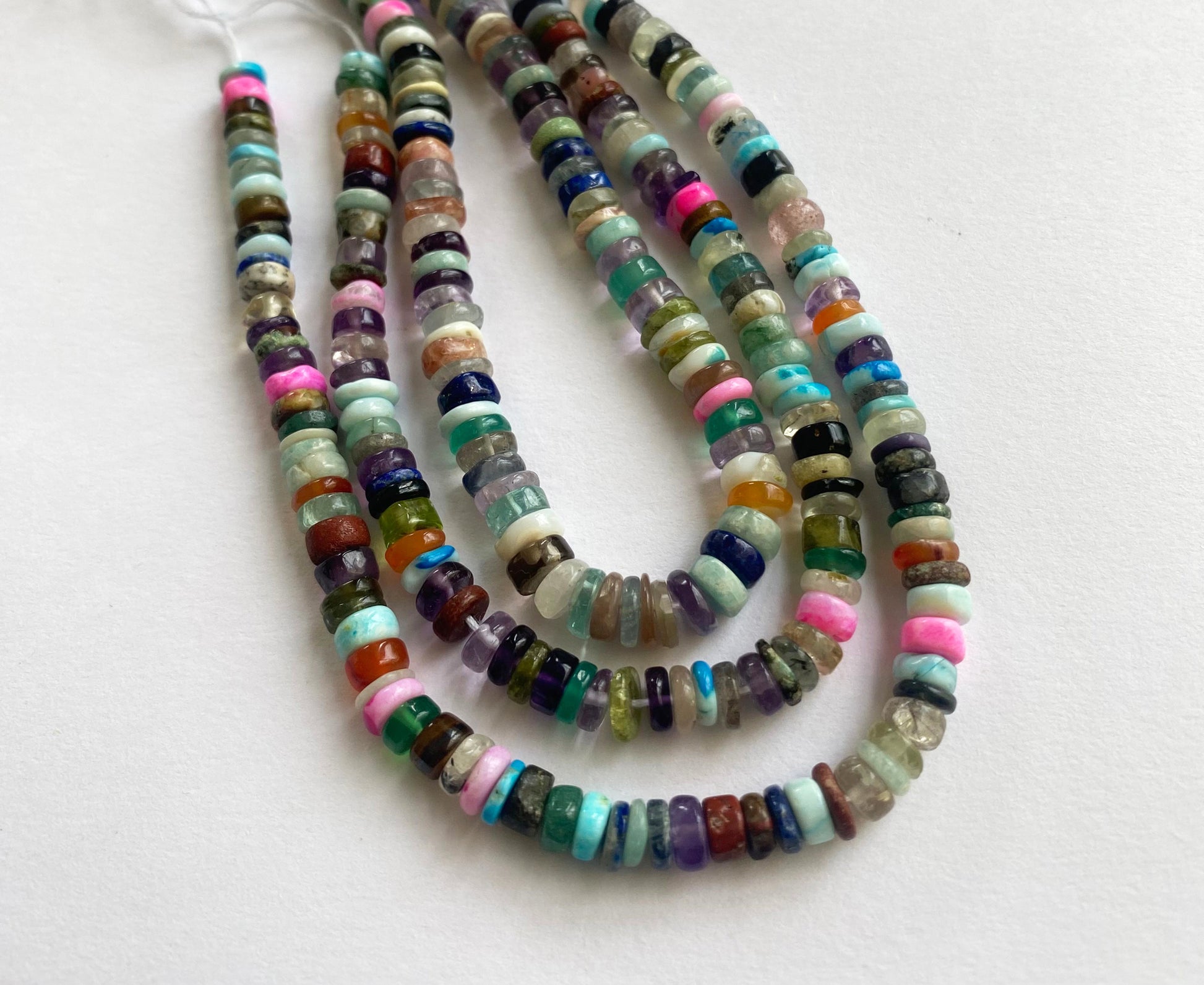 Vibrant, smooth wheel-shaped beads showcasing refined shine and sleek texture.