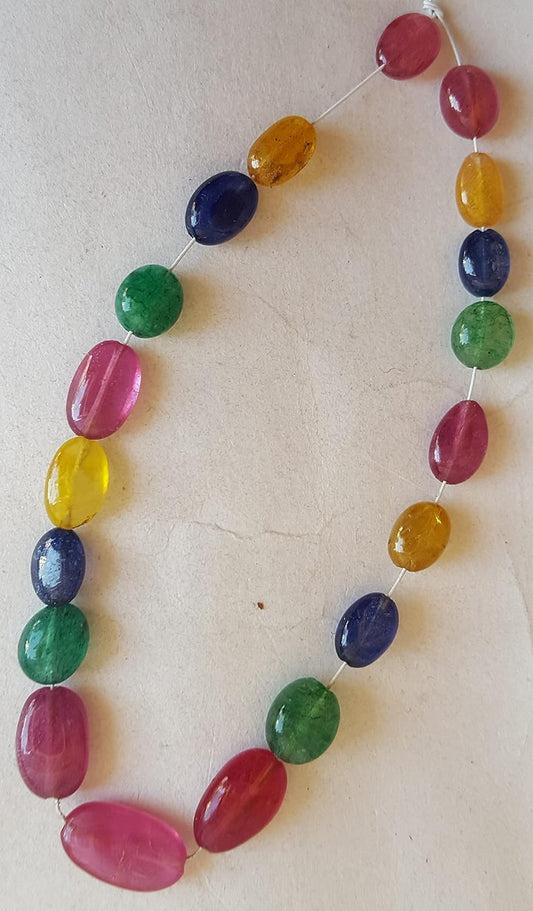  A vibrant multi-coloured strand featuring ruby, blue sapphire, yellow sapphire, and emerald beads on a white background.
