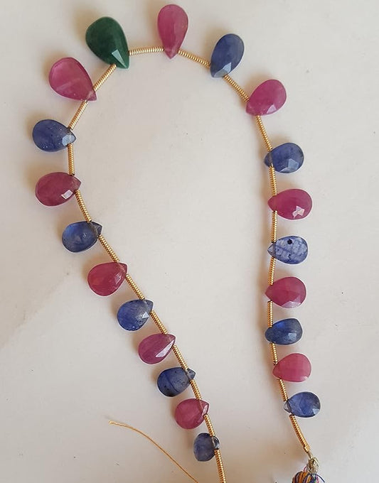A striking strand with multi-coloured beads, including ruby, blue sapphire, and emerald, set on a white background.