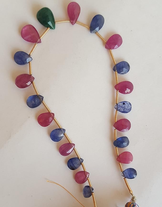 A striking strand with multi-coloured beads, including ruby, blue sapphire, and emerald, set on a white background.
