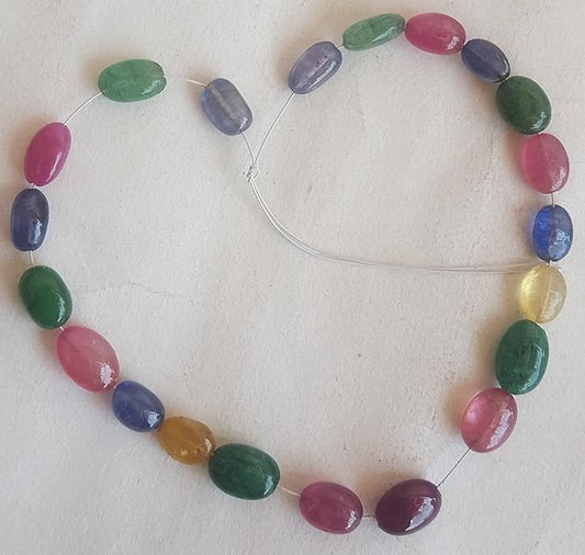 A striking strand with multi-coloured beads, including ruby, blue sapphire, yellow sapphire, and emerald, set on a white background.