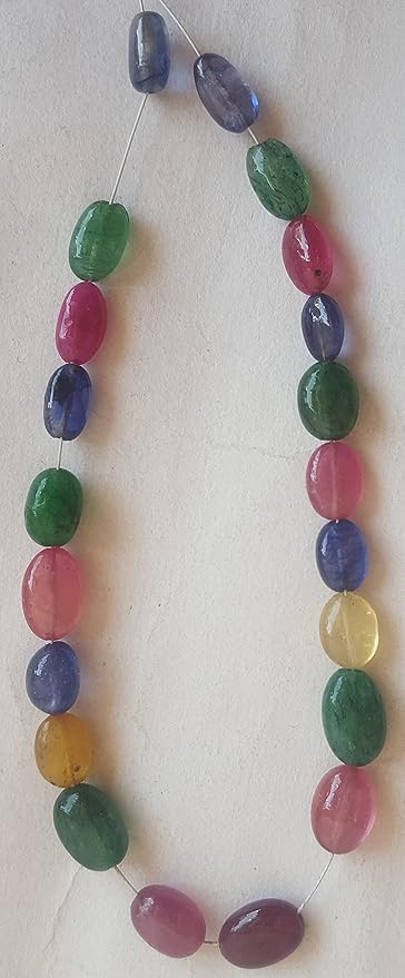 An elegant multi-coloured strand featuring ruby, blue sapphire, yellow sapphire, and emerald beads on a white background.