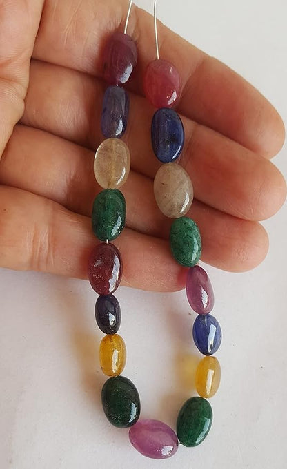 A striking strand with multi-coloured beads, including ruby, blue sapphire, yellow sapphire, and emerald, set on a white background.