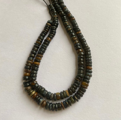 Stunning strand with 5mm to 5.5mm black tiger eye smooth wheel beads, ideal for a stylish accessory.