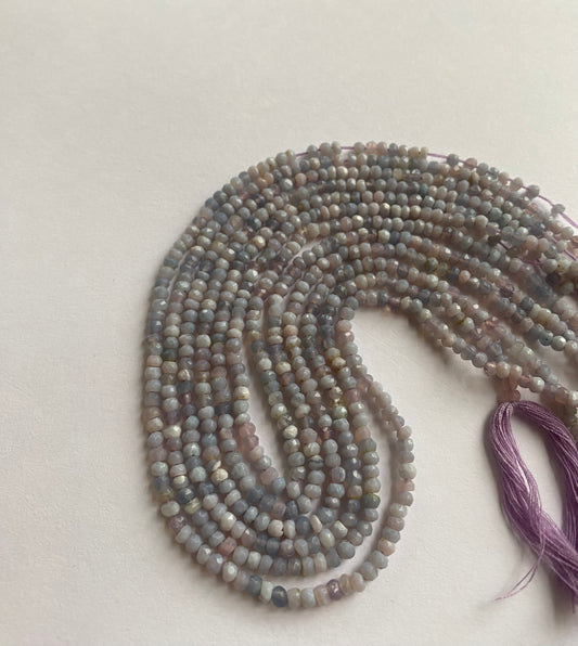 Strand of Faceted Rondelle  Lavender Opal  beads arranged neatly for artisan beading projects.