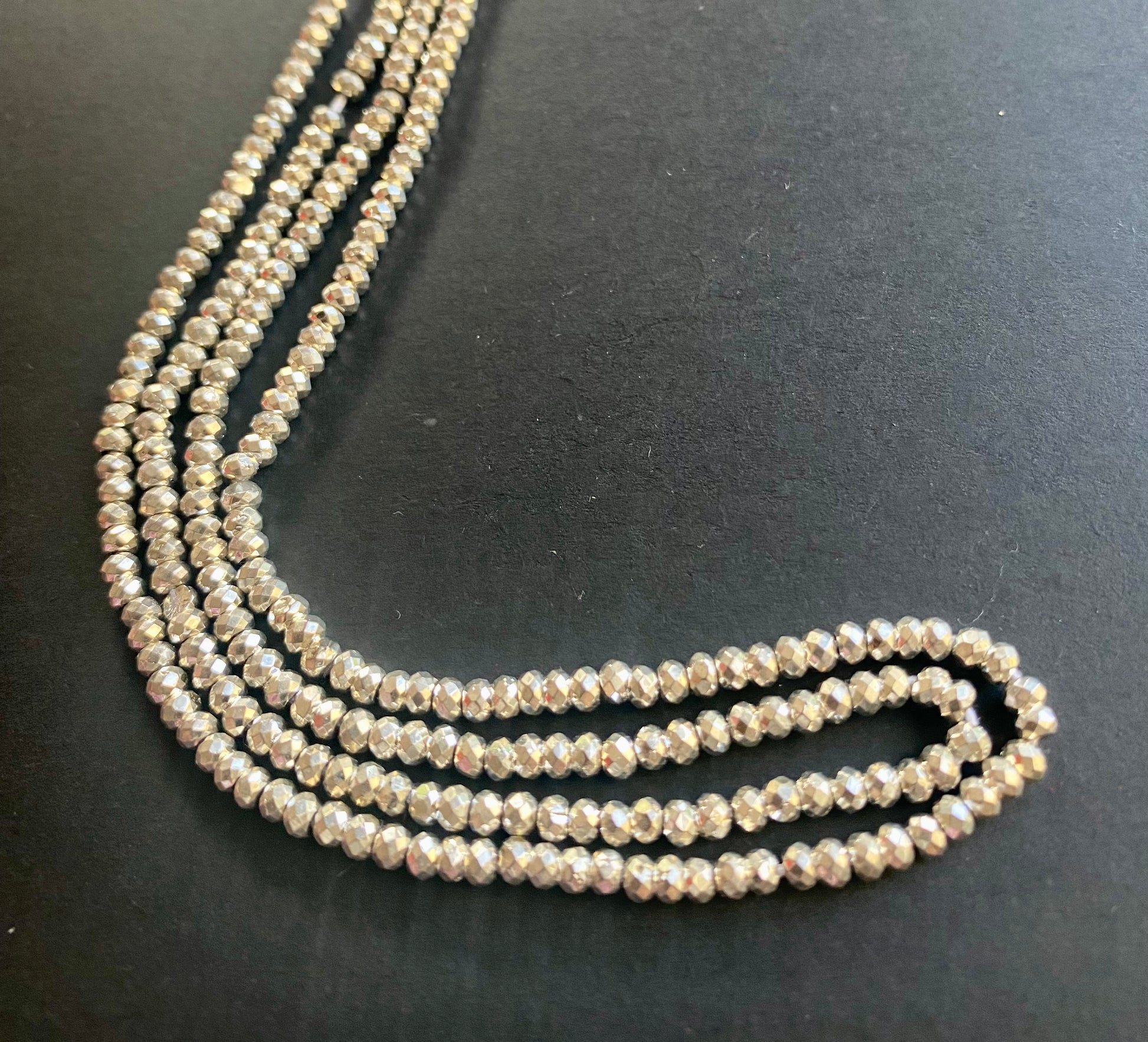 A stylish strand adorned with 3.1mm pyrite faceted rondelle beads, measuring 32cm in length and sparkling beautifully