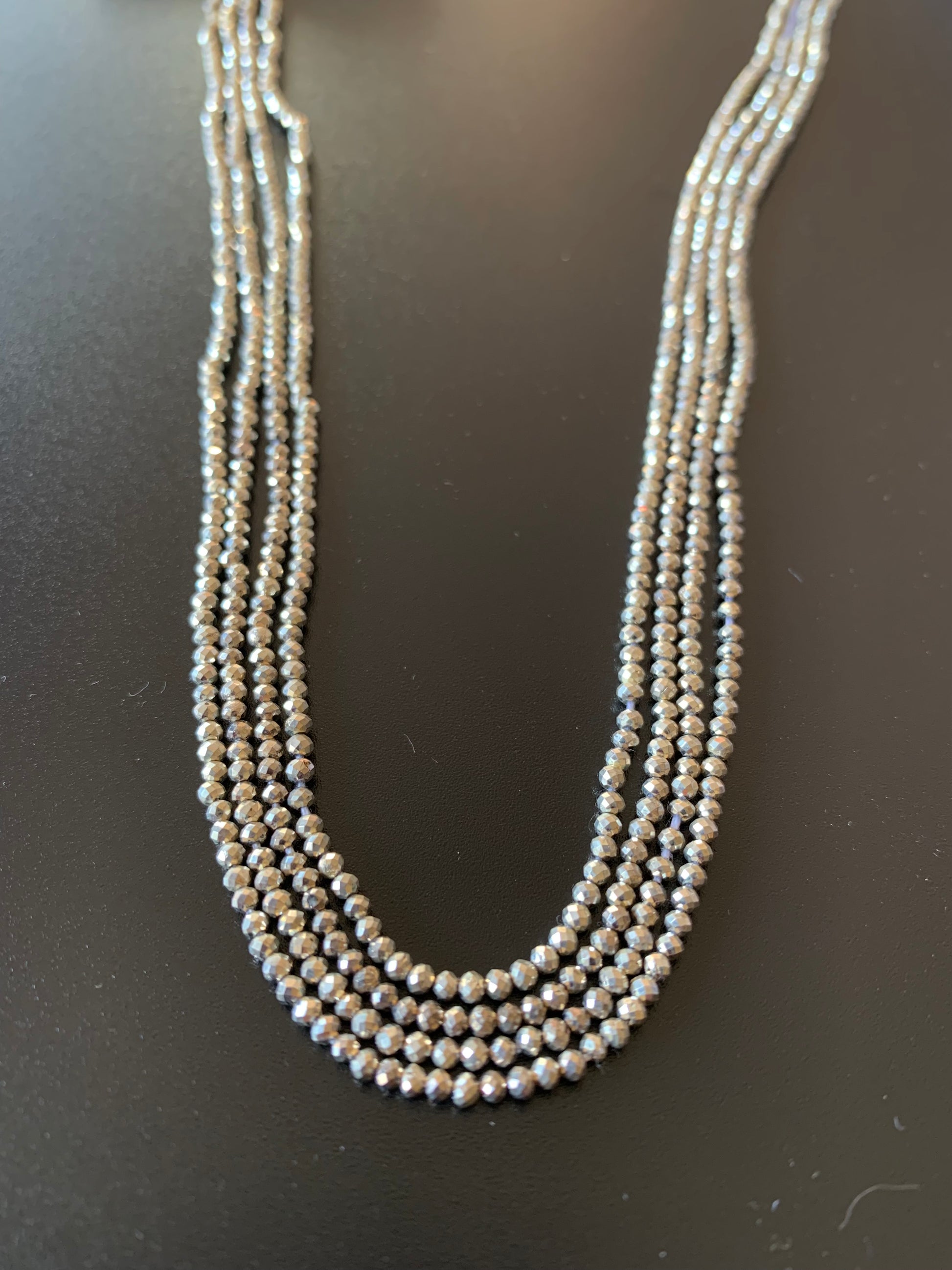  A vibrant strand of 2.1mm sliver pyrite faceted rondelle beads, highlighting their natural elegance and charm.