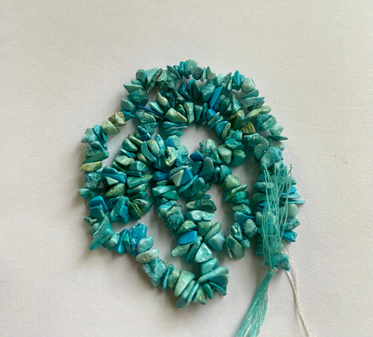 Elegant strand adorned with 5mm to 8mm natural turquoise chip stones, showcasing a rich blue colour.