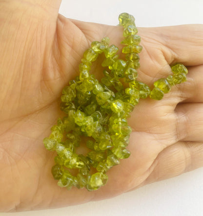 Beautiful Peridot gemstone chips 5 to 8mm showcasing a blend of fresh green hues and smooth textures ideal for artisan jewellery making.