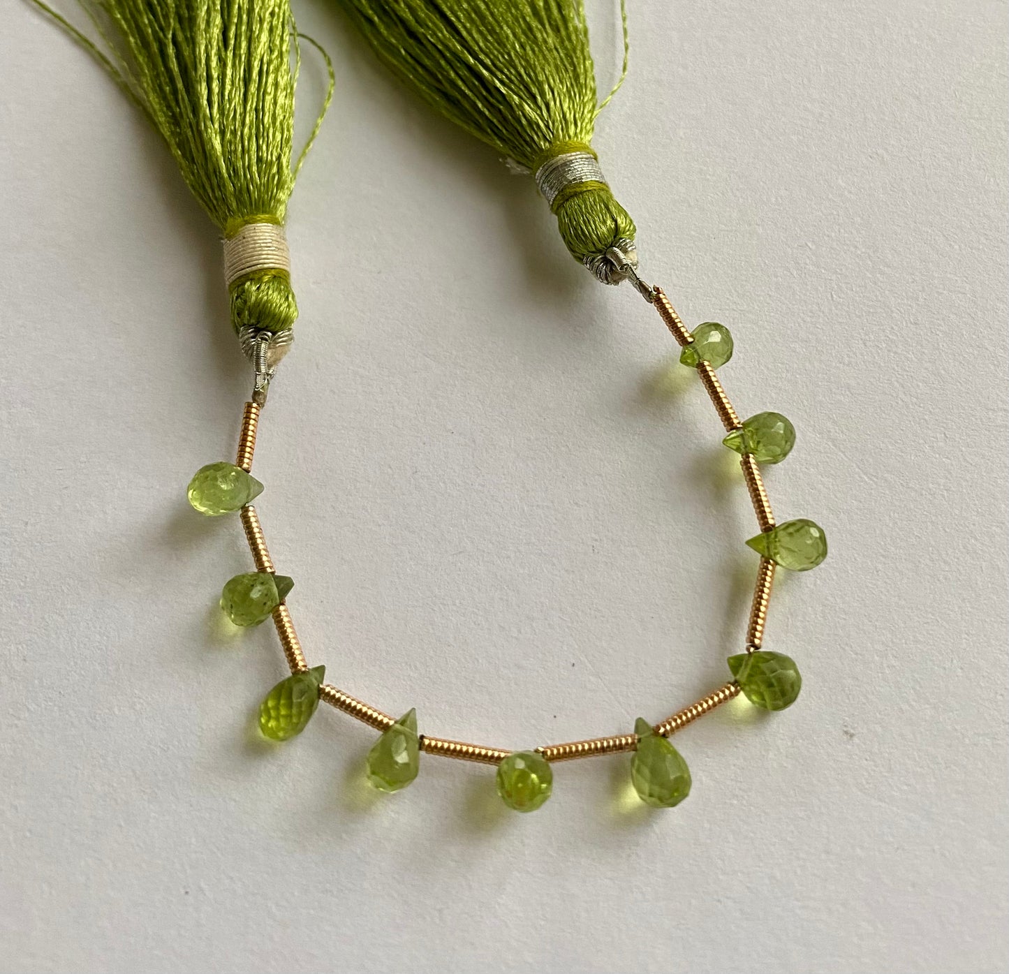 Beautiful  green peridot stones, tear-drop-shaped and faceted.