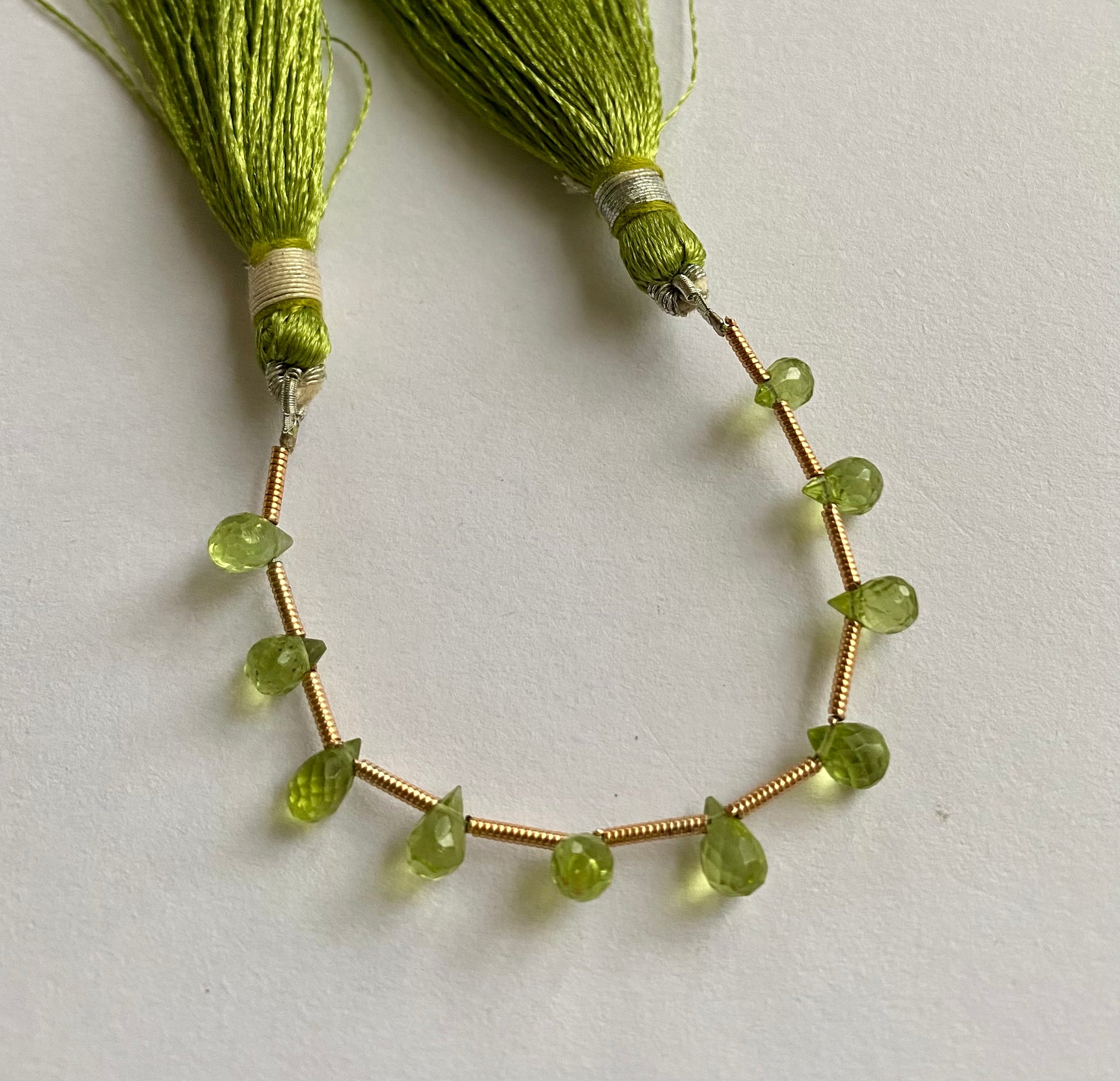 Beautiful  green peridot stones, tear-drop-shaped and faceted.