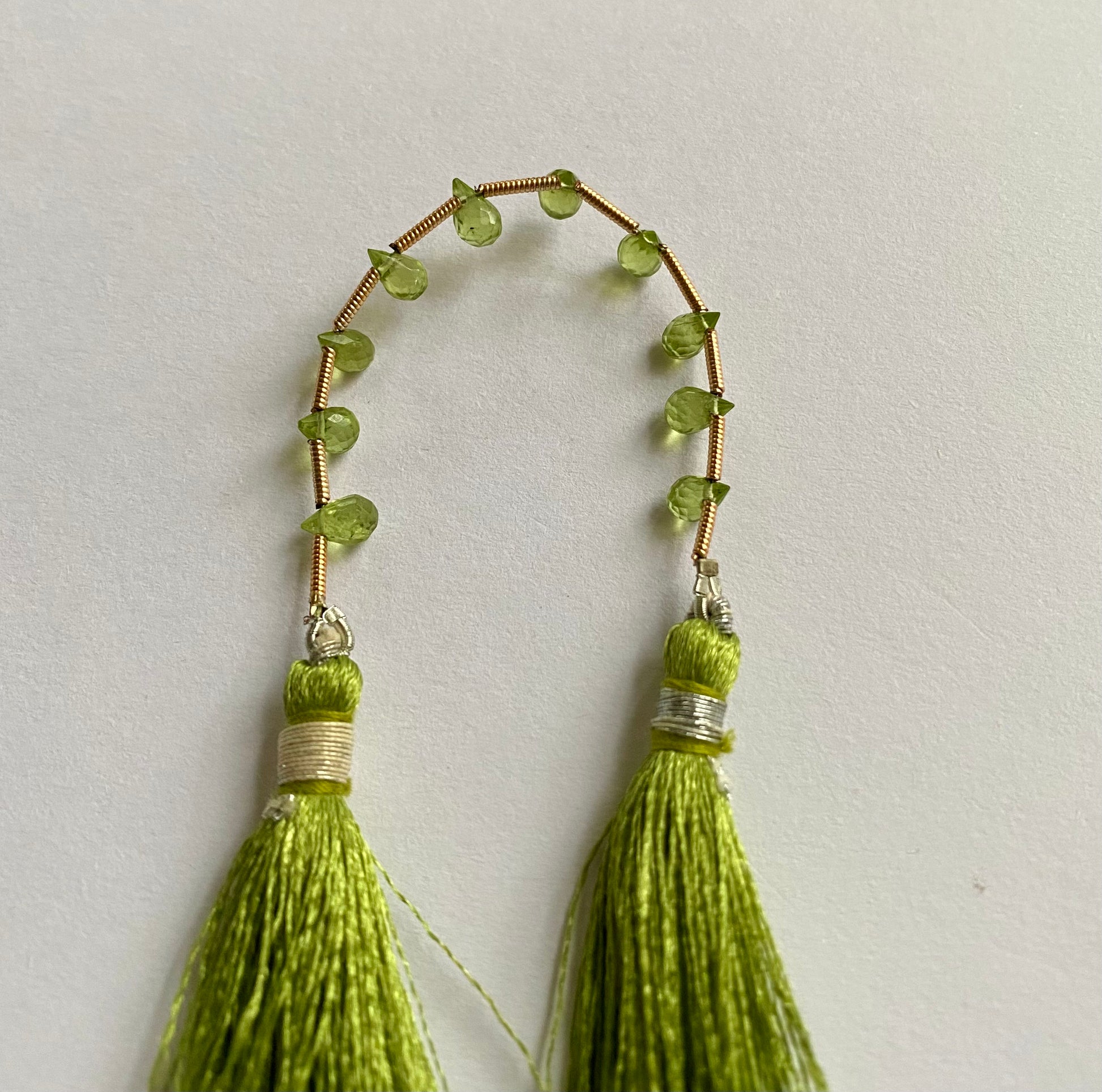 Beautiful  green Peridot stones, teardrop-shaped and faceted, measuring between 3.7mm and 4.4mm.