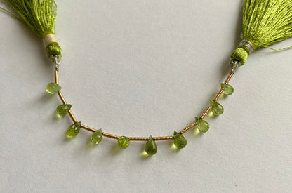 Elegant strand adorned with faceted teardrop peridot stones, showcasing a rich green colour.