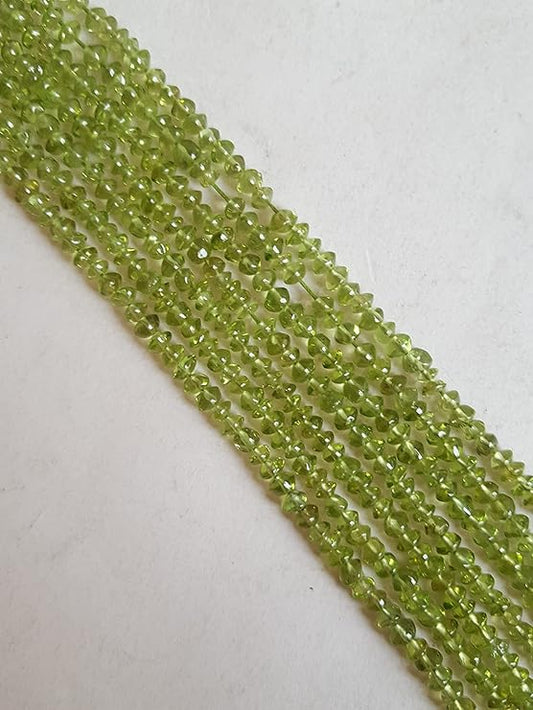 Strands featuring 3.5mm to 4.0mm faceted rondelle beads in a vibrant green colour, showcasing the beauty of Peridot in a wholesale bulk bunch.

