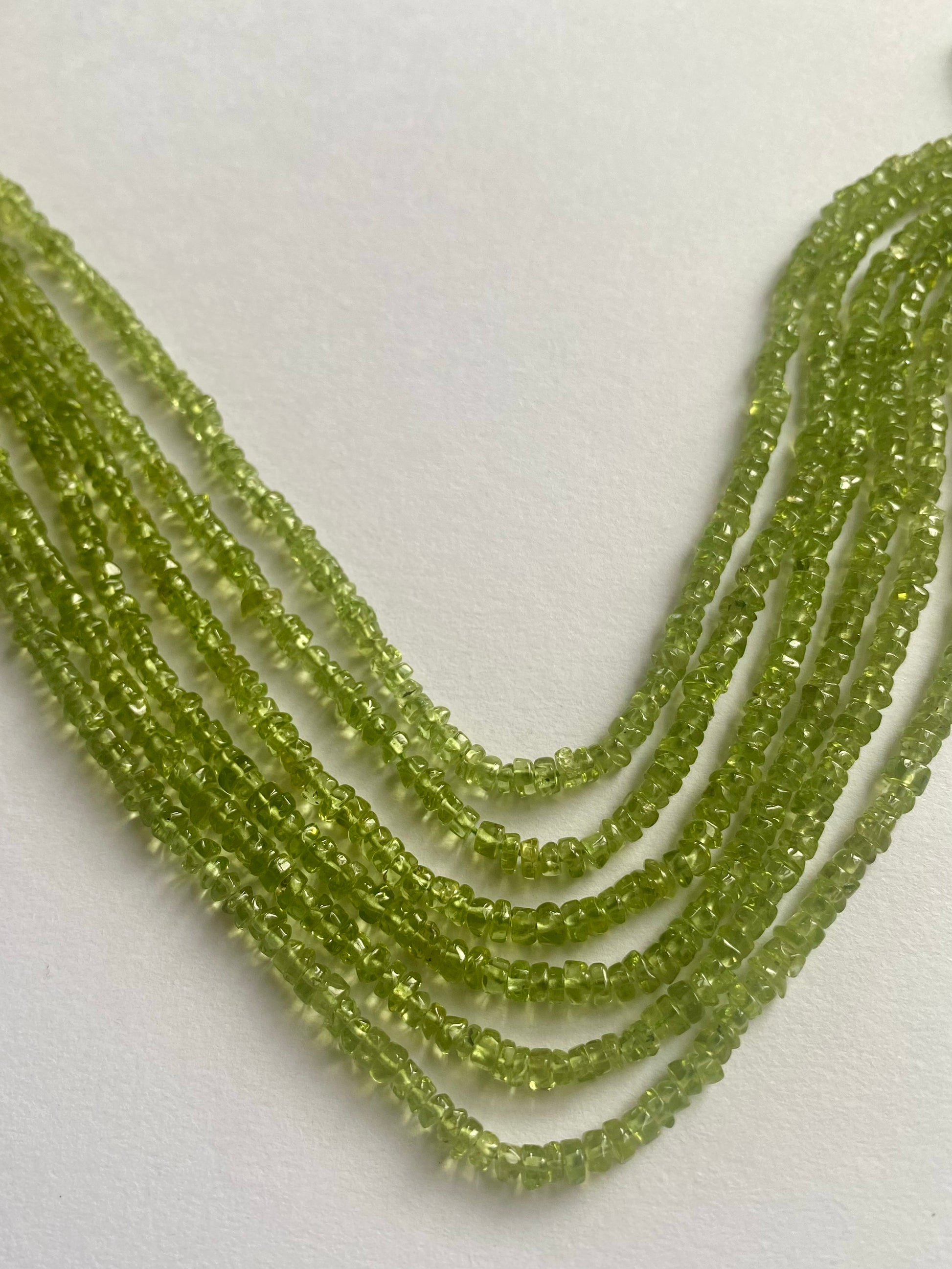 Beautiful strands of smooth green peridot beads, 3.5mm to 4mm in size, radiating a fresh and lively appearance.  