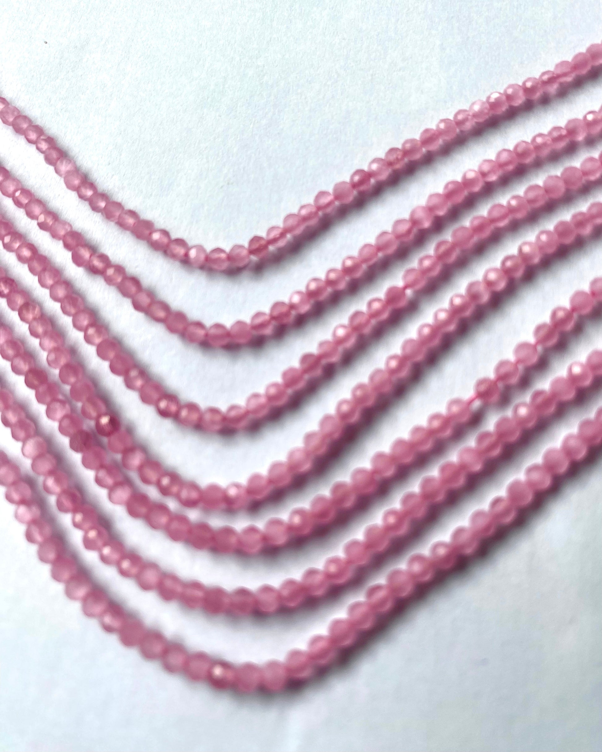  A collection of faceted quartz beads, sized 2.5mm, showcasing their stunning pink brilliance.  