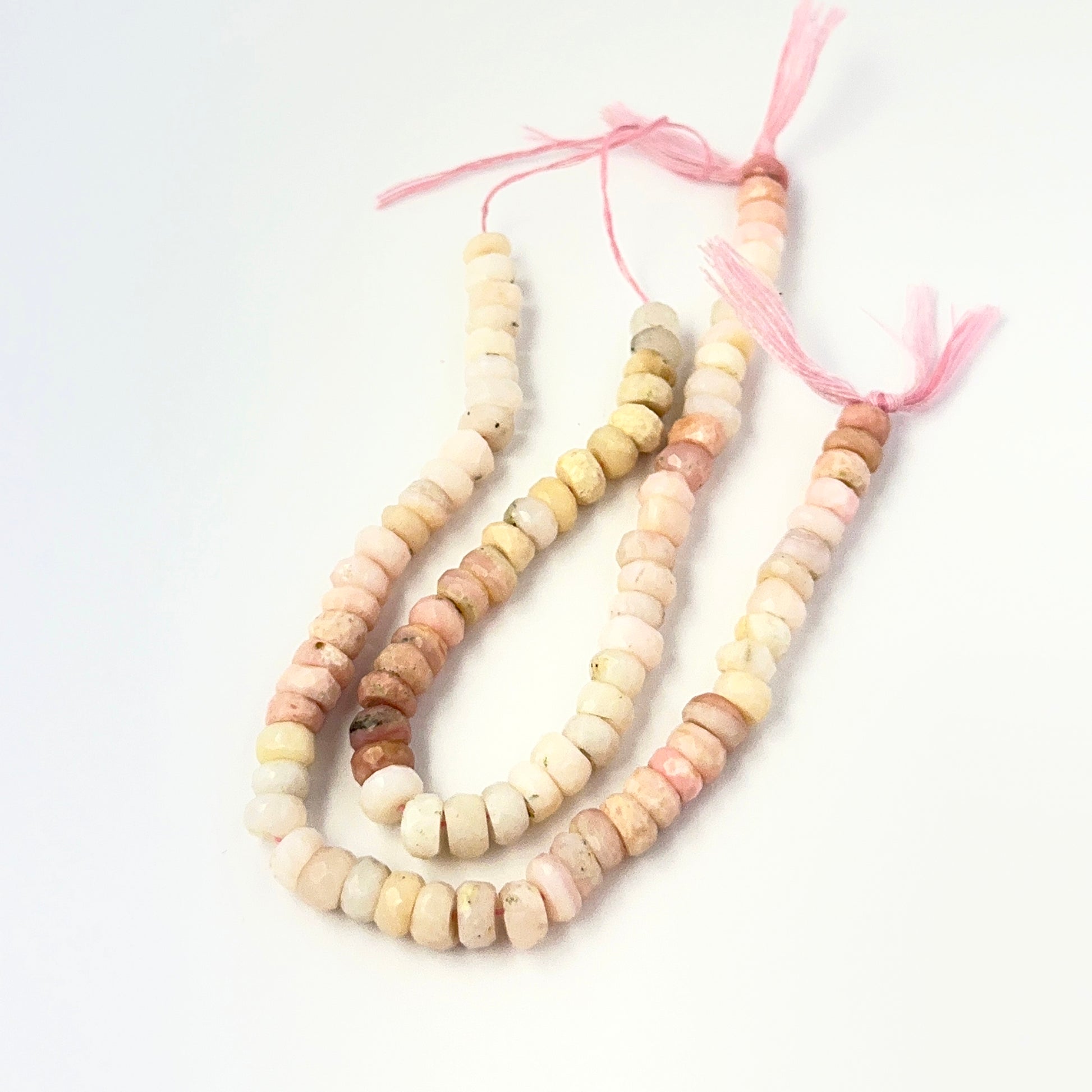 Genuine Pink Opal stone beads in faceted rondelle cut, showcasing soft blush tones for DIY jewellery design.