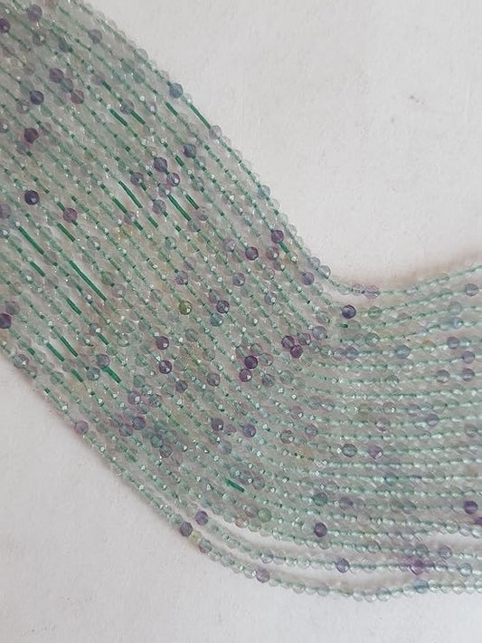 A long strand of green and purple prehnite faceted rondelle beads, showcasing their natural beauty and unique colours.