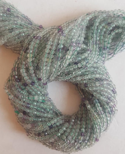 Striking strands of natural prehnite beads, with 2mm green and purple faceted rondelles, perfect for adding colour to creations.