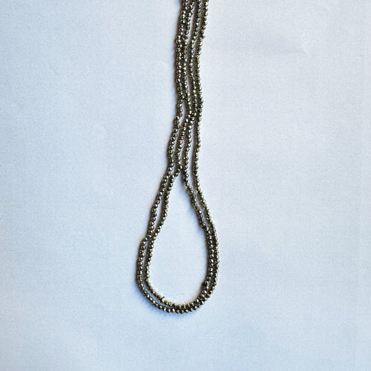 Pyrite faceted rondelle beads glimmer beautifully in a neatly arranged 32cm strand.